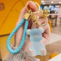 Blue jelly bear keychain with sparkling rhinestones, gold hardware, and chic braided strap. - Blue