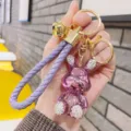 Chic purple metallic rhinestone rabbit keychain with braided rope strap and gold hardware. - Purple