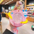 Cute rabbit keychain with UFO projection lamp and colorful ambient light, detailed closeup. - Pink