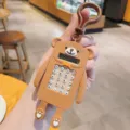 Cute brown bear electronic calculator keychain, portable detail view with cute cartoon design. - Coffee