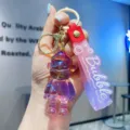 Crystal resin cartoon doll keychain with pink strap, cute backpack pendant accessory. - Red