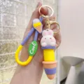Close-up detail of cute cartoon rabbit ice cream keychain with silicone strap and metal ring. - Telescopic Ice Cream Animal - White Rabbit