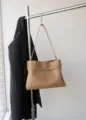 Classic retro camel leather shoulder bag detail, elegant minimalist design with metal clasp. - Apricot