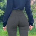Detailed view of women's high-waisted push-up skinny jeans showing back fit and pockets. - S / Gray