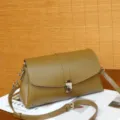 Stylish olive green leather crossbody bag featuring an elegant H-shaped metal clasp and strap. - Yucca Green