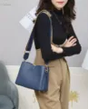 Stylish blue leather shoulder bag for women with wide strap and gold hardware for daily use. - Sapphire Blue
