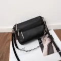 Detailed view of black genuine leather multi-zipper crossbody bag with metal chain strap. - 27*7*17CM / Black