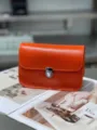 Orange genuine leather crossbody bag with metal lock, chic Litchi pattern shoulder handbag. - Orange