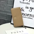 Detailed view of the genuine leather long wallet in light khaki with textured finish and zipper. - Apricot