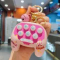 Cute space gamepad keychain mini toy with pink fidget pendant detail view close up - Pink