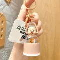 Detail shot of cute cartoon bear keychain with portable camping light design and metal ring. - Brown