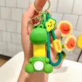 Cute cartoon dinosaur keychain with telescopic neck, fun stress relief bag charm detail view. - Telescopic Sitting Dinosaur - Yellow Neck