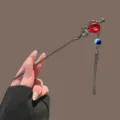 Metal snake hair stick with red ring and blue beaded tassel for stylish vintage hairstyles. - Gunmetal Peace Buckle Snake