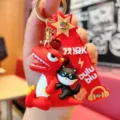 PVC dinosaur cat keychain detail view, cute cartoon bag charm accessory pendant. - Cartoon Dinosaur / Red