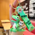 Cute cartoon dinosaur wolf PVC keychain detail shot, trendy bag charm with metal ring. - Cartoon Dinosaur / Light Green
