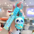 Detailed close-up shot of cute electroplated panda doll keychain pendant with colorful silicone strap. - Colorful Backpack Panda - Blue