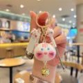 Cute cat keychain set close-up, portable mini nail clipper and ear pick charm pendant detail view. - White Cat / L