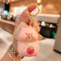 Cute pink cartoon pig squeeze keychain with strawberry charm and bag pendant detail. - Pink Pig - Strawberry