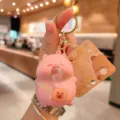 Detailed view of cute pink cartoon bubble-blowing bear decompression keychain pendant. - Pink Capybara