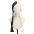 Detail view of the black and white split color braided wig, showcasing neat pigtails. - Black and White