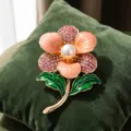 Exquisite enamel flower brooch featuring pink rhinestones, pearl and green leaves accessory. - Gradient Pink Rhinestone Pearl Center Green Leaf Flower Style (823362)