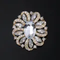 Detailed shot of a luxury gold-tone floral brooch sparkling with clear rhinestones and crystals. - Floral Style (XD015-1) / Gold White