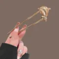 Gold metal U-shaped hair stick with cute dolphin design, elegant bun hair pin accessory. - Golden Mini Dolphin Style