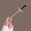 Silver sword hair stick with black handle and red pendant, elegant hair accessory for buns. - Enamel Sword with Red Rhinestone Pendant Hair Stick / Silver
