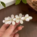 Elegant floral rhinestone spring hair clip in gold finish with white pearl petals for women. - Double Flower Spring Clip / Gold