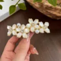 Gold flower spring hair clip with white cat-eye stone and rhinestones for elegant styling. - Four Flower Spring Clip / Gold