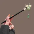 Traditional Chinese style hair stick with elegant floral and jade tassel design for women. - Three Flower Celadon Tassel Wooden Hairpin