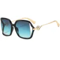 Gafas de sol cat-eye oversize con lentes degradadas azules y varillas metalicas doradas. - C3 Marco Oro Negro Lente Gris Azul