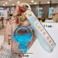 Detailed view of the cute acrylic liquid bear keychain with glitter, showcasing dimensions and strap. - Blue