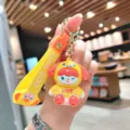 Close-up detail of the cute cartoon dog keychain pendant, vibrant electroplated finish and strap. - Electroplated Cinnamoroll - Yellow