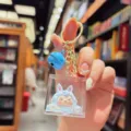 Cute acrylic quicksand keychain featuring a blue monster doll pendant, ideal bag charm and gift. - Blue