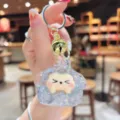 Cute quicksand glitter dumpling keychain detail, lovely trendy toy pendant with golden bell. - White