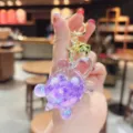 Details of the cute transparent liquid turtle keychain with purple glitter, perfect bag charm. - Luminous Beads—Purple