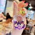 Transparent liquid quicksand lucky cat keychain with cute glitter and gold ring for bag charm. - Purple