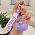 Cute purple liquid turtle backpack keychain detail showing clear acrylic and silicone strap. - Purple