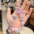 Cute purple beaded phone charm with cartoon doll pendant, sweet aesthetic accessory for girls. - Purple