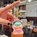 Cute liquid quicksand keychain with a lovely cartoon doll pendant, detailed close-up shot. - Beads-Red