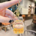 Acrylic quicksand keychain pendant, cute cartoon character design with glittering liquid, gold hardware. - Orange