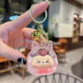 Portachiavi con sabbia mobile liquida e ciondolo mostro carino con campanello d'oro. - Perle-Rosso