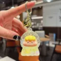 Cute liquid quicksand keychain with floating glitter and adorable cartoon doll pendant for bags. - Beads-Yellow