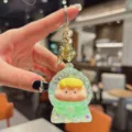 Cute liquid floating glitter keychain with adorable cartoon character, detail shot. - Liquid Green