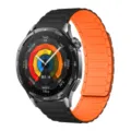 Closeup of smart watch with black metallic case and vibrant orange magnetic silicone strap UI. - 18mm / Black & Orange