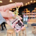 Detailed close-up of cute cartoon Nezha mini Rubik cube keychain pendant with gold ring. - Nezha Cube - Child