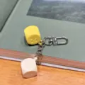 Colorful macaron dice keychain detail shot, fun bar game accessory and bag pendant gift. - Yellow and White