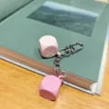 Pink dice keychain macaron style bag pendant metal chain charm accessory detail view - White & Pink