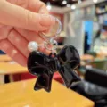 Korean style black bow keychain with white pearl pendant, cute acrylic bag charm accessory. - Black